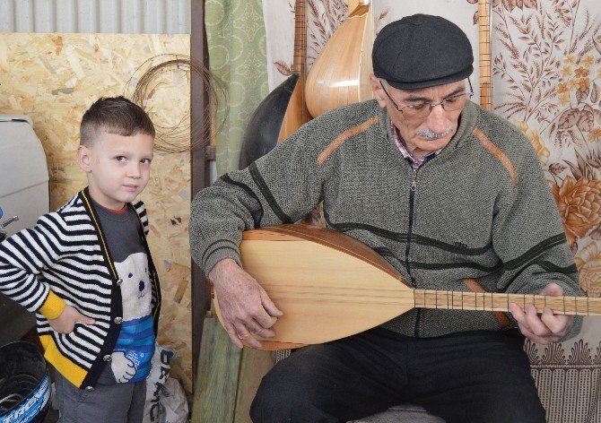 Dede-torun hem saz yapıyor, hem de çalıyor